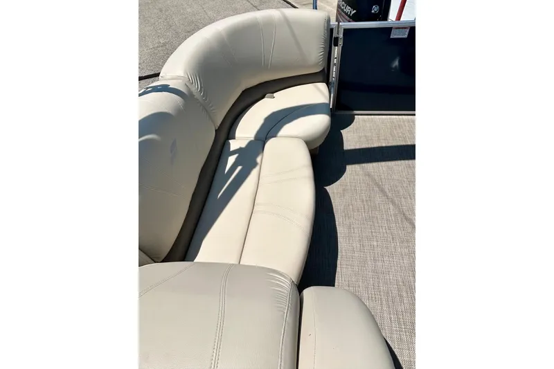 Slide: The Image of 2017 Starcraft CX 23 RE boat with beige seating and carpeted flooring. - 18