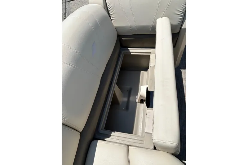 Slide: The Image of 2017 Starcraft CX 23 RE boat seat storage compartment, open and empty. - 12