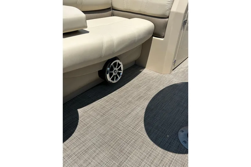 Slide: The Image of 2017 Starcraft CX 23 RE boat interior with beige seating and speaker detail. - 35