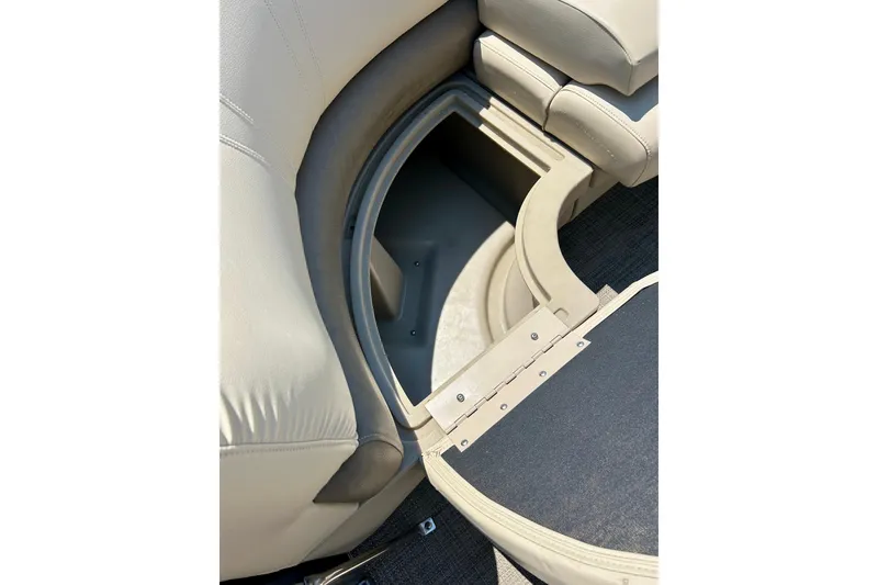 Slide: The Image of 2017 Starcraft CX 23 RE boat storage compartment with beige seating and carpeted flooring. - 11