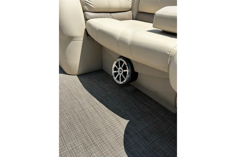 Slide: The Image of 2017 Starcraft CX 23 RE boat interior with beige seating and speaker detail. - 36