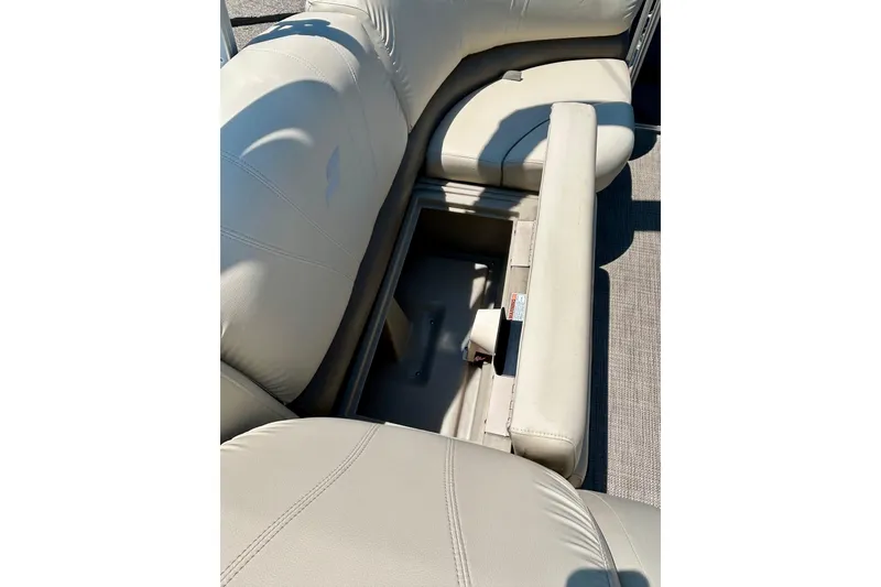 Slide: The Image of 2017 Starcraft CX 23 RE boat with open storage compartment in beige seating. - 19