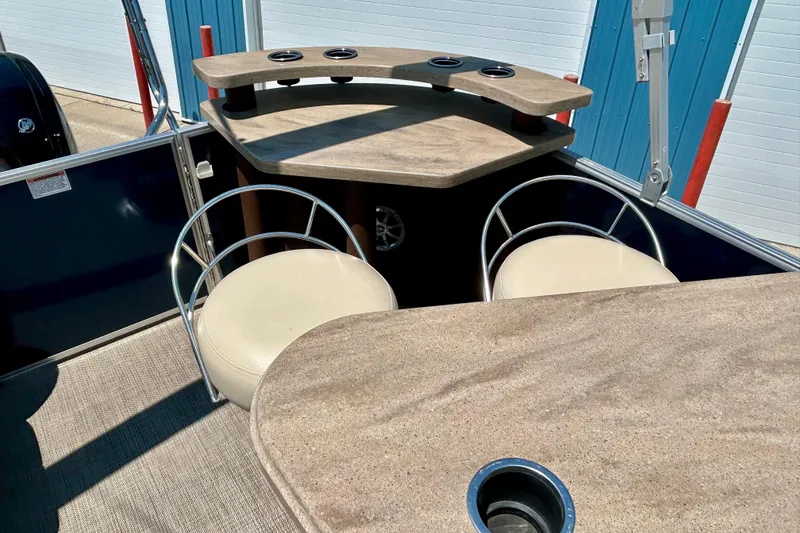 Slide: The Image of 2017 Starcraft CX 23 RE boat interior with seating and cup holders. - 17