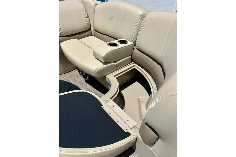 Slide: The Image of 2017 Starcraft CX 23 RE boat interior with beige seating and built-in cup holders. - 10