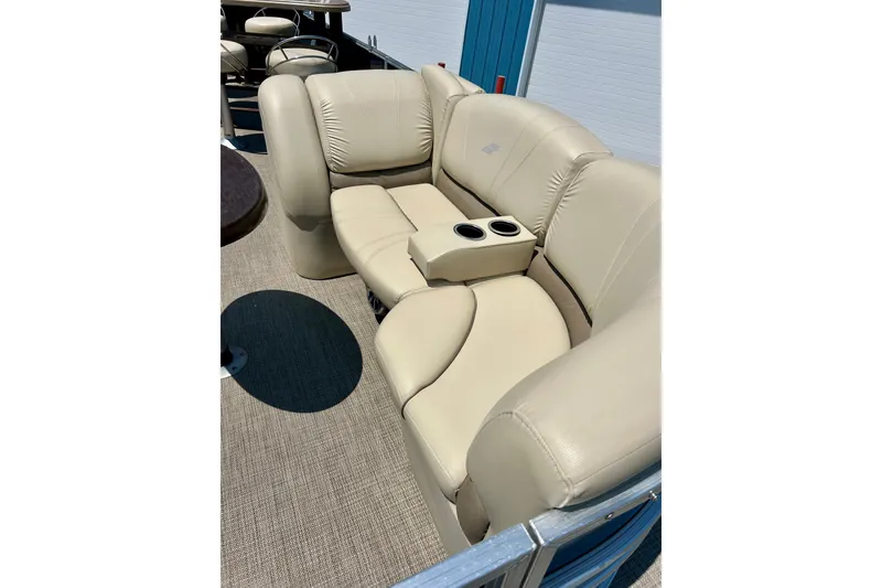 Slide: The Image of Luxurious beige seating on 2017 Starcraft CX 23 RE pontoon boat with cup holders. - 8