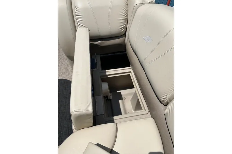 Slide: The Image of 2017 Starcraft CX 23 RE boat seat with open storage compartment. - 14