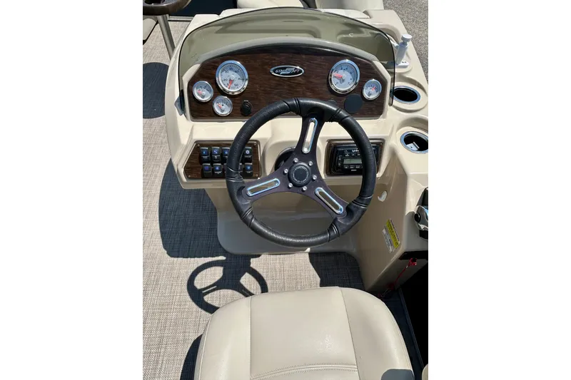 Slide: The Image of Steering console of 2017 Starcraft CX 23 RE boat with gauges and controls. - 13