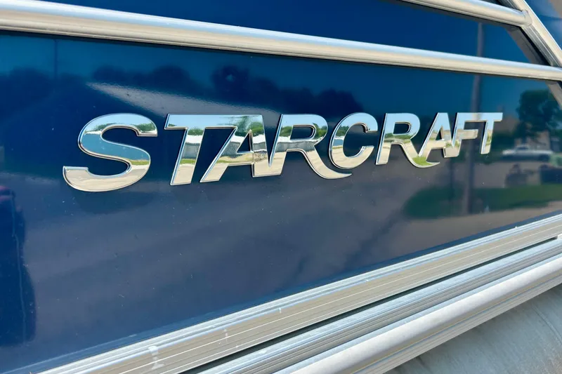 Slide: The Image of Chrome "Starcraft" logo on a 2017 CX 23 RE boat, reflecting sunlight. - 5