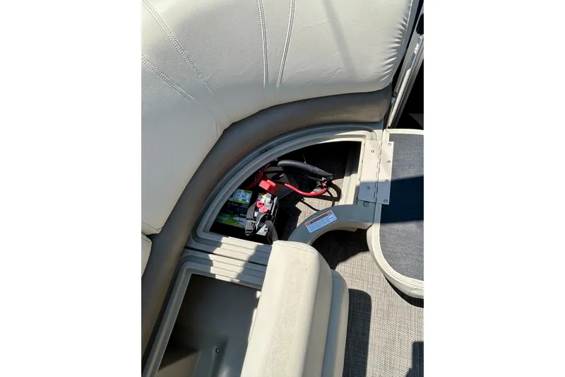 Slide: The Image of 2017 Starcraft CX 23 RE boat interior showing storage compartment with battery. - 20
