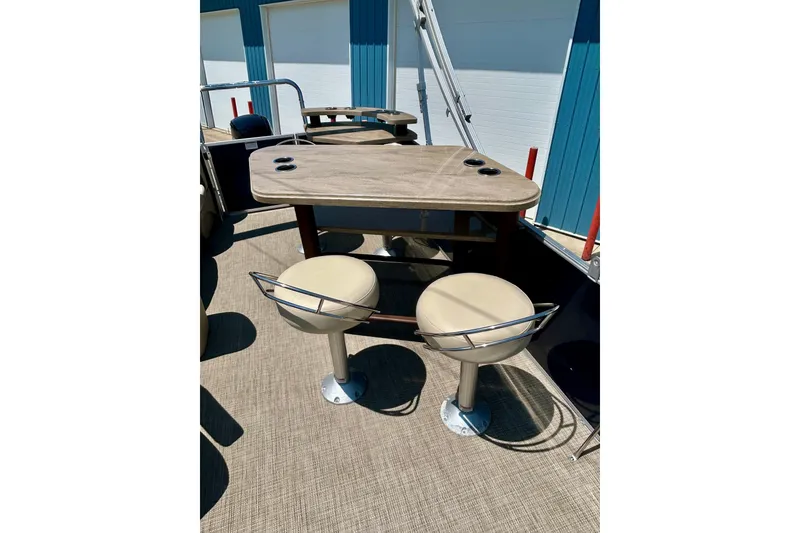 Slide: The Image of 2017 Starcraft CX 23 RE boat interior with table and swivel chairs. - 15