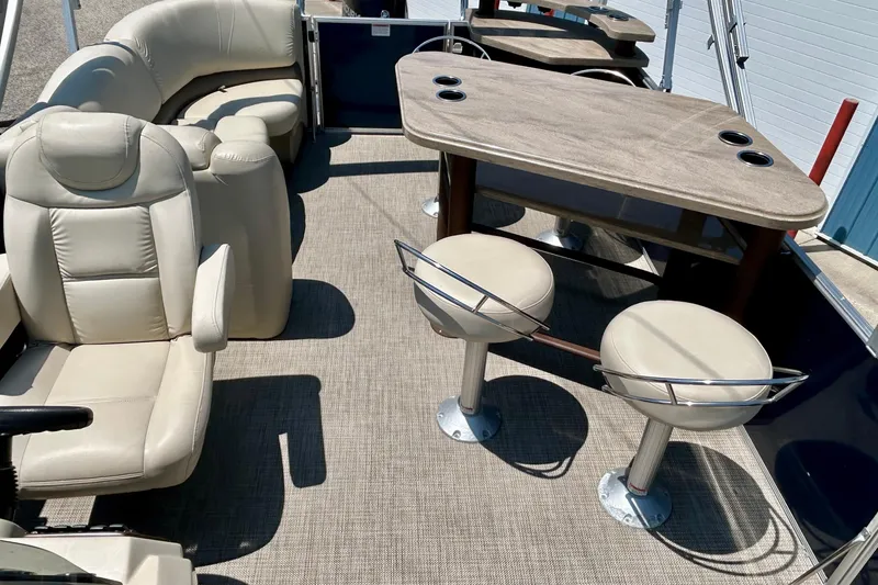 Slide: The Image of 2017 Starcraft CX 23 RE boat interior with beige seating and table setup. - 25