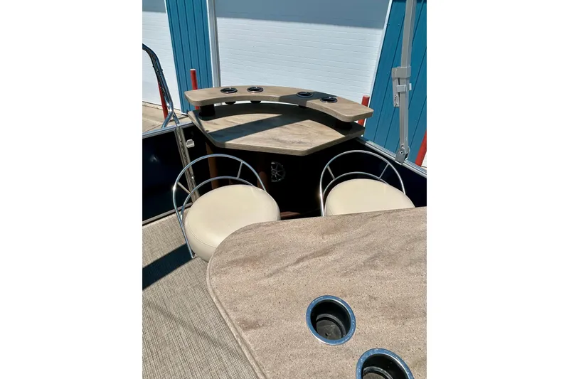 Slide: The Image of 2017 Starcraft CX 23 RE boat interior with seating and cup holders. - 16
