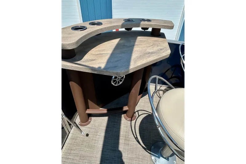 Slide: The Image of 2017 Starcraft CX 23 RE boat interior with bar table and seating. - 29