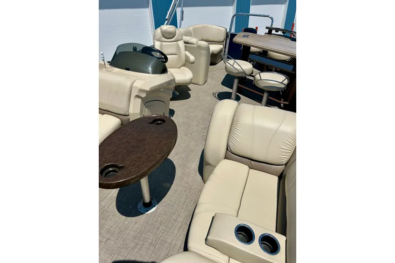 Slide: The Image of Luxurious interior of 2017 Starcraft CX 23 RE pontoon boat with plush seating and tables. - 34