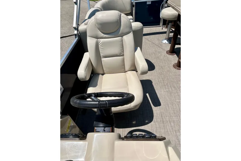 Slide: The Image of Captain's chair and steering wheel on 2017 Starcraft CX 23 RE pontoon boat. - 23
