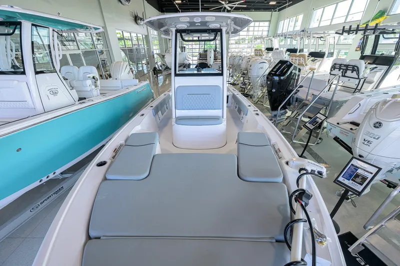 Slide: The Image of 2027 Sportsman Masters 227 Bay Boat in showroom, featuring sleek design and modern amenities. - 21