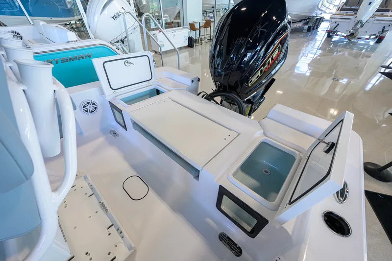 Slide: The Image of 2027 Sportsman Masters 227 Bay Boat interior with storage compartments and outboard motor. - 36
