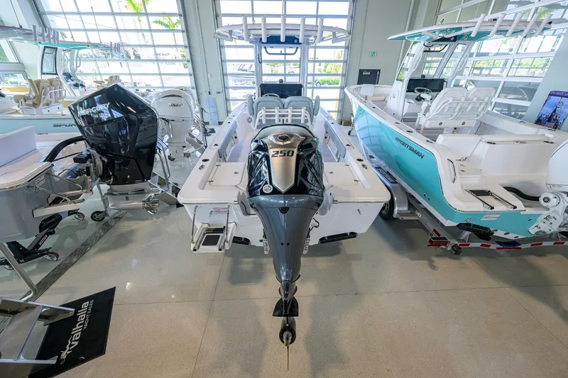 Slide: The Image of 2027 Sportsman Masters 227 Bay Boat with powerful outboard motor in showroom display. - 4