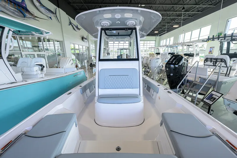 Slide: The Image of 2027 Sportsman Masters 227 Bay Boat interior in showroom, featuring sleek seating and modern design. - 22