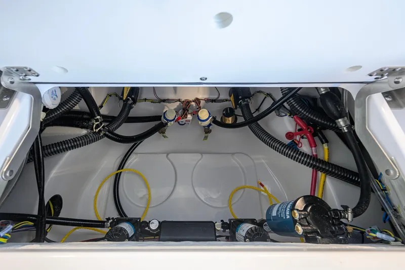 Slide: The Image of 2027 Sportsman Masters 227 Bay Boat wiring and plumbing compartment. - 41