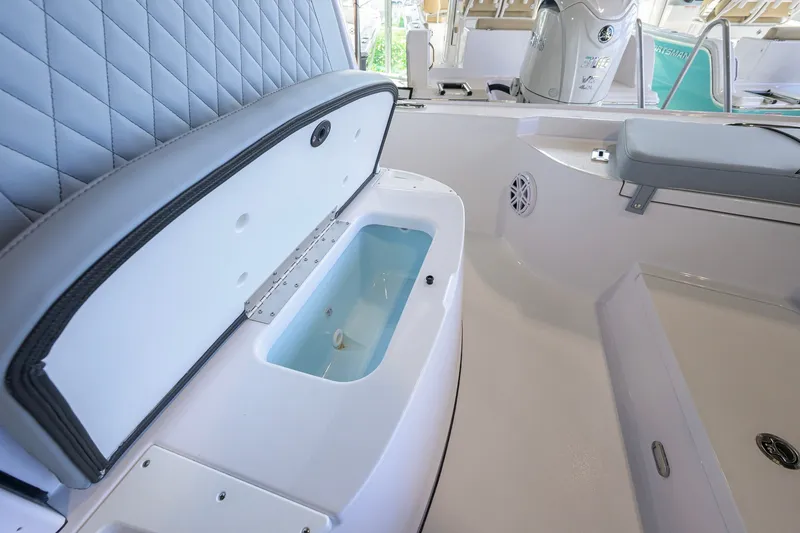 Slide: The Image of Interior view of 2027 Sportsman Masters 227 Bay Boat with open storage compartment. - 23