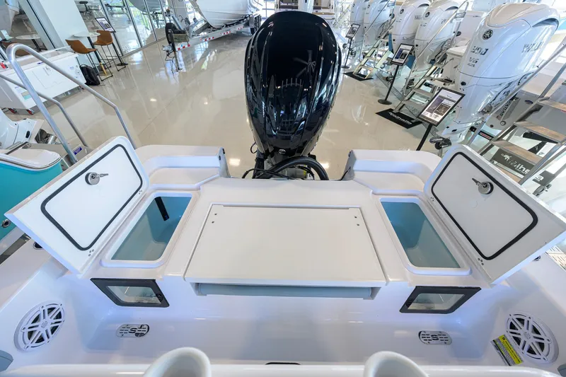 Slide: The Image of 2027 Sportsman Masters 227 Bay Boat interior with storage compartments and outboard motor. - 32