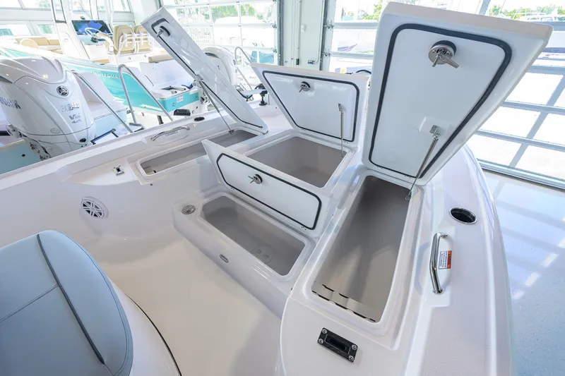 Slide: The Image of 2027 Sportsman Masters 227 Bay Boat with open storage compartments and Yamaha engines. - 24