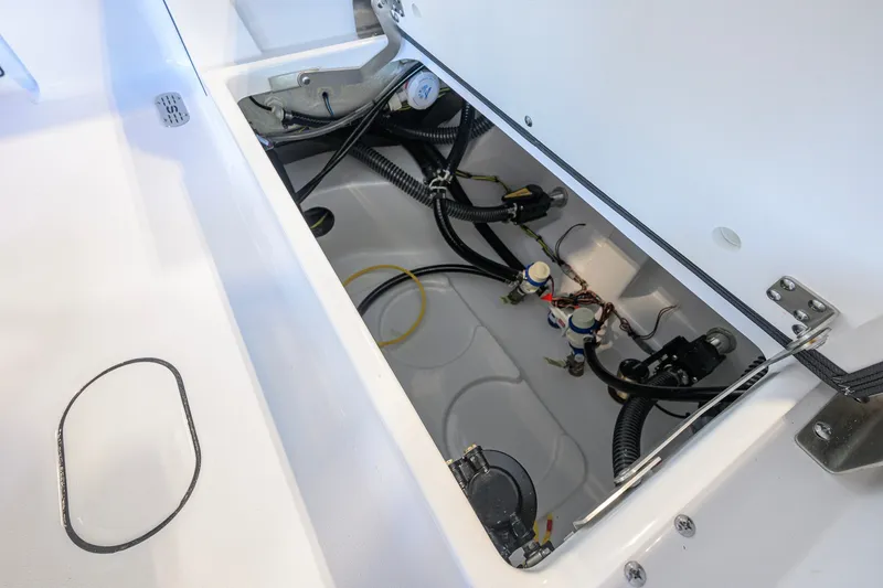 Slide: The Image of Open compartment of 2027 Sportsman Masters 227 Bay Boat showing internal wiring and components. - 42