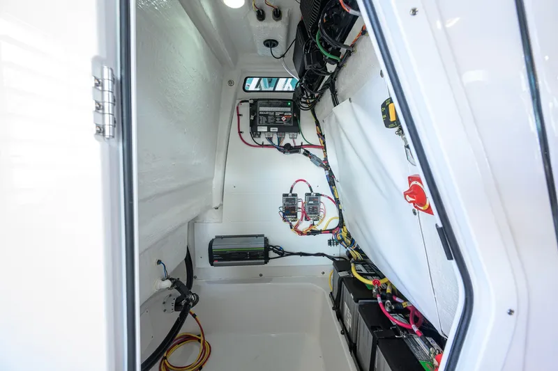 Slide: The Image of Electrical compartment of 2027 Sportsman Masters 227 Bay Boat, showcasing wiring and components. - 43