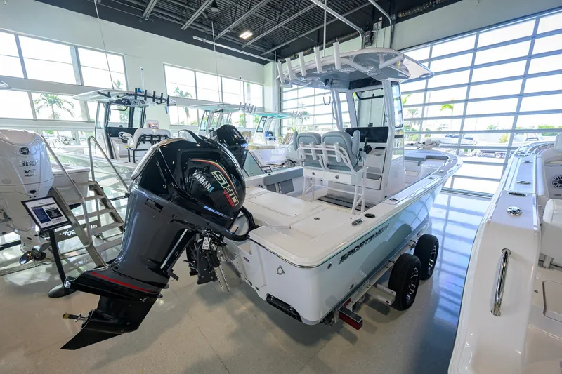 Slide: The Image of 2027 Sportsman Masters 227 Bay Boat displayed in showroom with Yamaha outboard engine. - 5