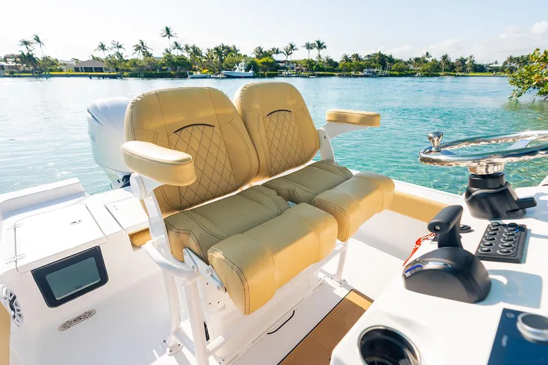 Slide: The Image of Manufacturer Provided Image: 2025 Sportsman Masters 227 Bay Boat interior with tan seats, steering wheel, and water view. - 6