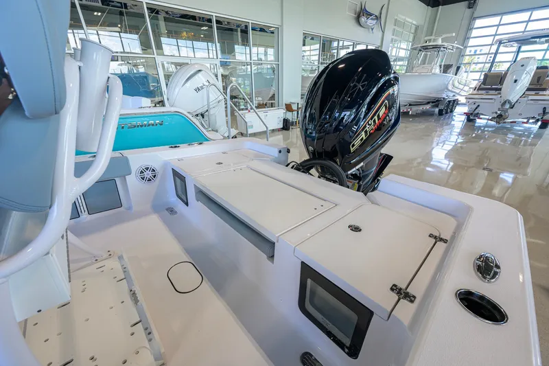 Slide: The Image of 2027 Sportsman Masters 227 Bay Boat interior with engine, displayed in showroom. - 35