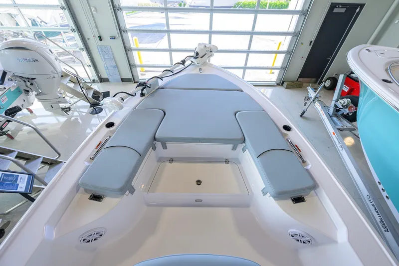 Slide: The Image of 2027 Sportsman Masters 227 Bay Boat interior with cushioned seating and storage compartments. - 12