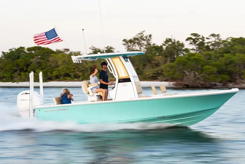 The Image of Manufacturer Provided Image: 2025 Sportsman Masters 227 Bay Boat cruising on water with American flag. - 0