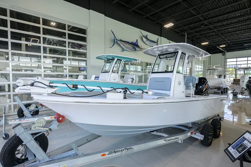 The Image of 2027 Sportsman Masters 227 Bay Boat displayed in a showroom on a trailer. - 0