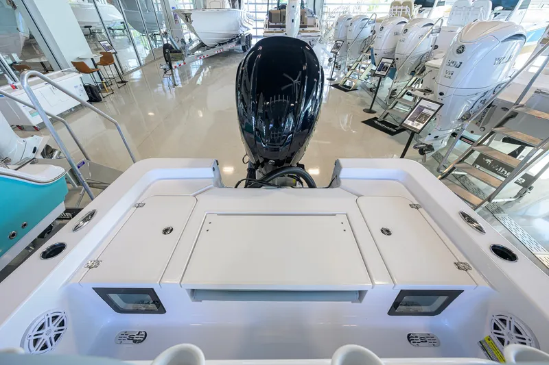 Slide: The Image of 2027 Sportsman Masters 227 Bay Boat interior with modern outboard motor in showroom. - 31