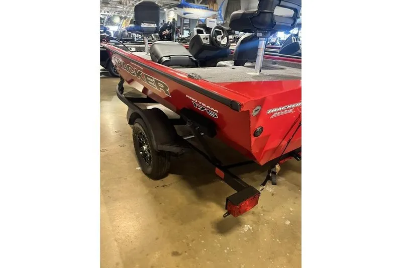 Slide: The Image of 2026 Tracker Pro Crappie 175 boat, red exterior, displayed indoors on a trailer. - 8