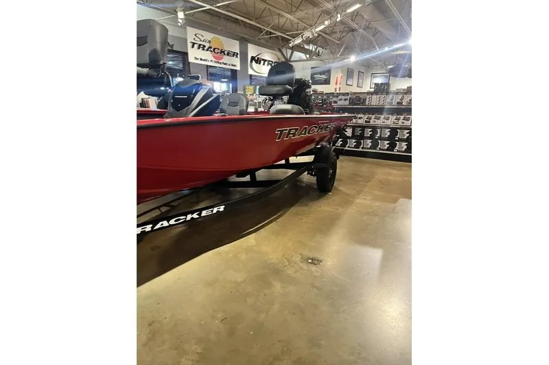 Slide: The Image of 2026 Tracker Pro Crappie 175 boat displayed in showroom, featuring sleek red design. - 12