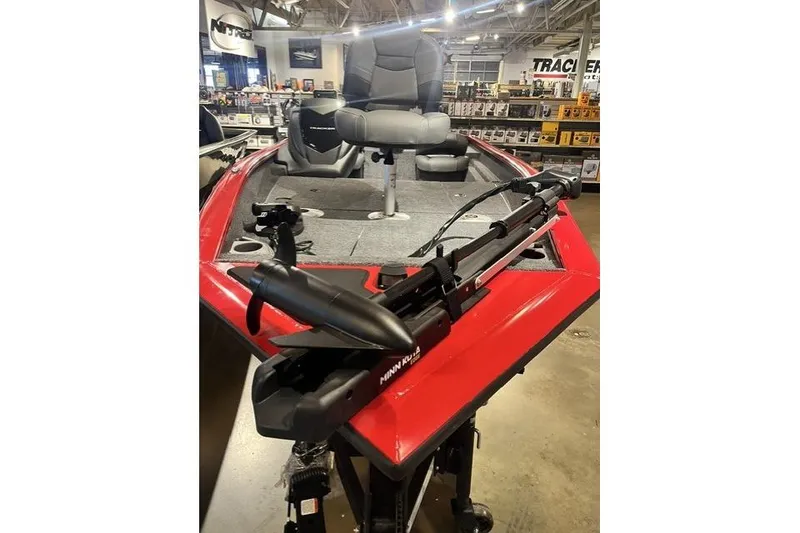 Slide: The Image of 2026 Tracker Pro Crappie 175 boat with red exterior and fishing equipment in showroom. - 10