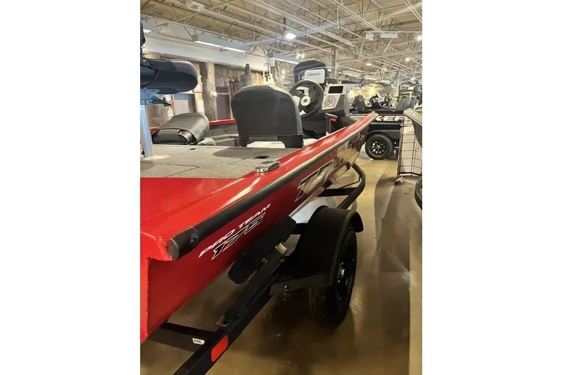 Slide: The Image of 2026 Tracker Pro Crappie 175 boat in showroom, featuring sleek red design and modern seating. - 3
