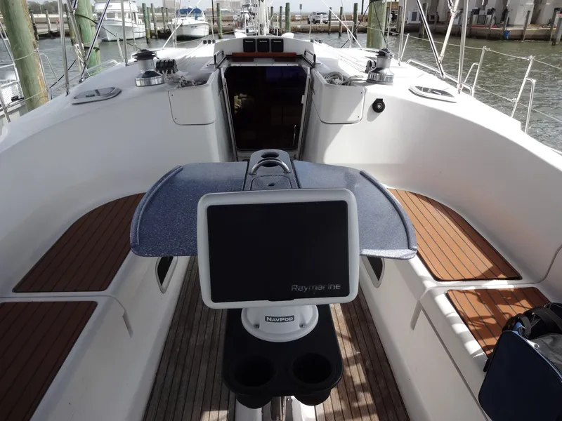 Slide: The Image of The cockpit of a 2009 Hunter 50 with a Raymarine display and wooden benches. - 15