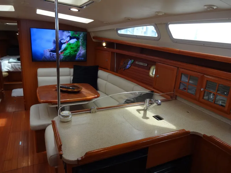 Slide: The Image of Interior of a 2009 Hunter 50 sailboat with cozy seating, wooden furnishings, and modern amenities. - 36