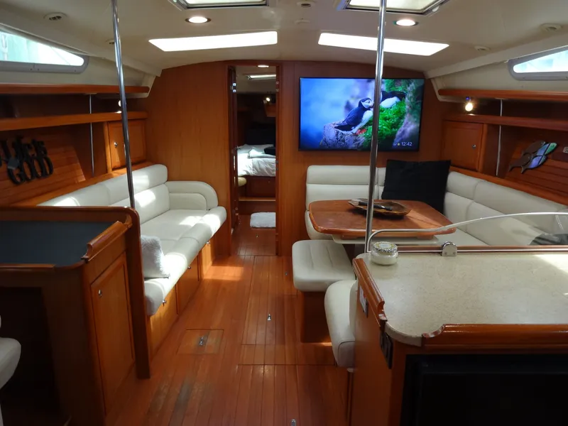 Slide: The Image of Interior of a 2009 Hunter 50 sailboat with elegant wood finishes and cozy seating areas. - 35