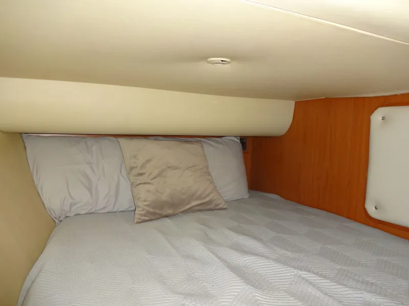 Slide: The Image of The cabin of a 2009 Hunter 50 features a cozy bed with pillows. - 42