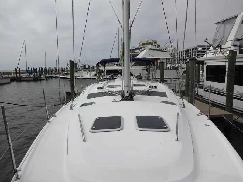 Slide: The Image of A 2009 Hunter 50 sailboat docked in a marina, surrounded by other boats. - 23