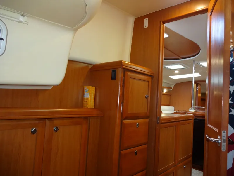 Slide: The Image of Interior of a 2009 Hunter 50 with wooden cabinetry and storage units. - 43