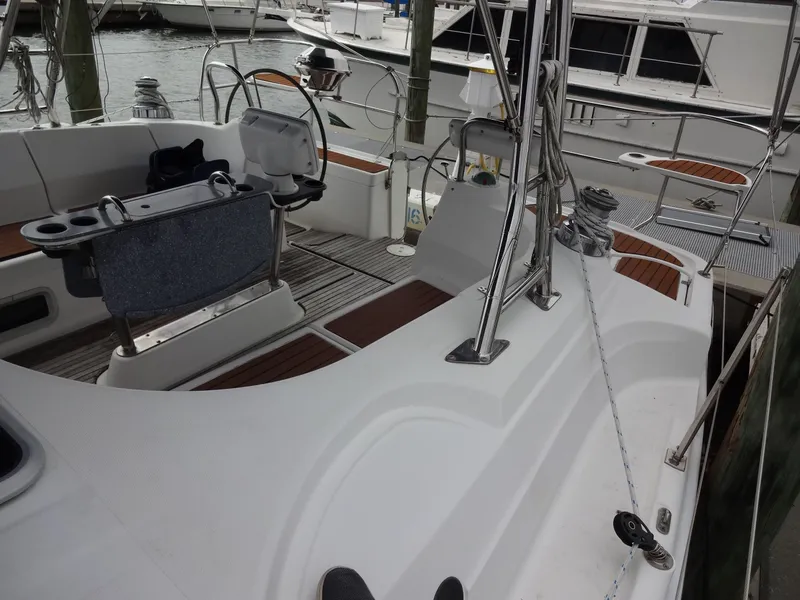 Slide: The Image of The image shows the deck of a 2009 Hunter 50, docked at a marina. - 26