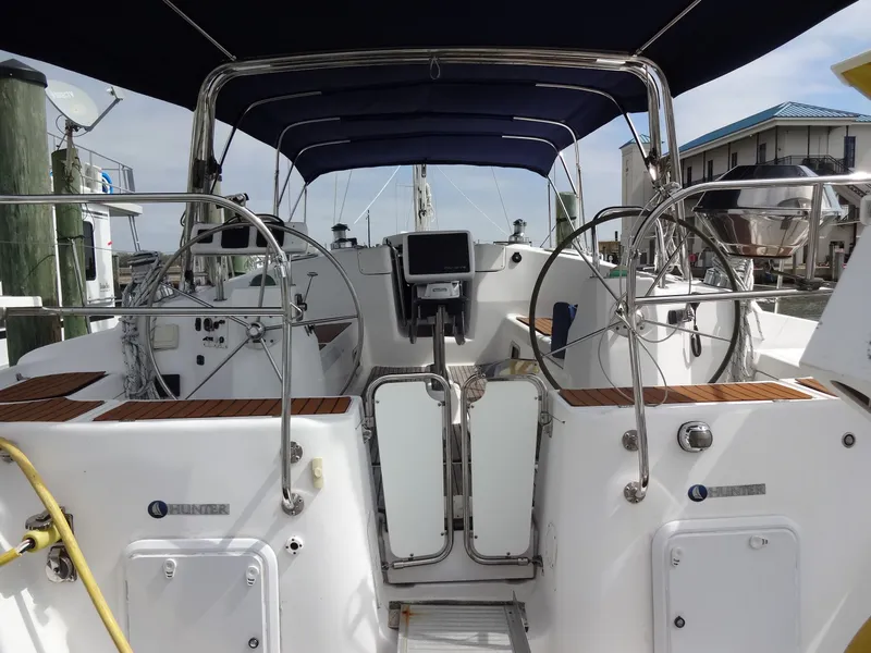 Slide: The Image of The cockpit of a 2009 Hunter 50 with dual steering wheels and a central navigation system. - 7
