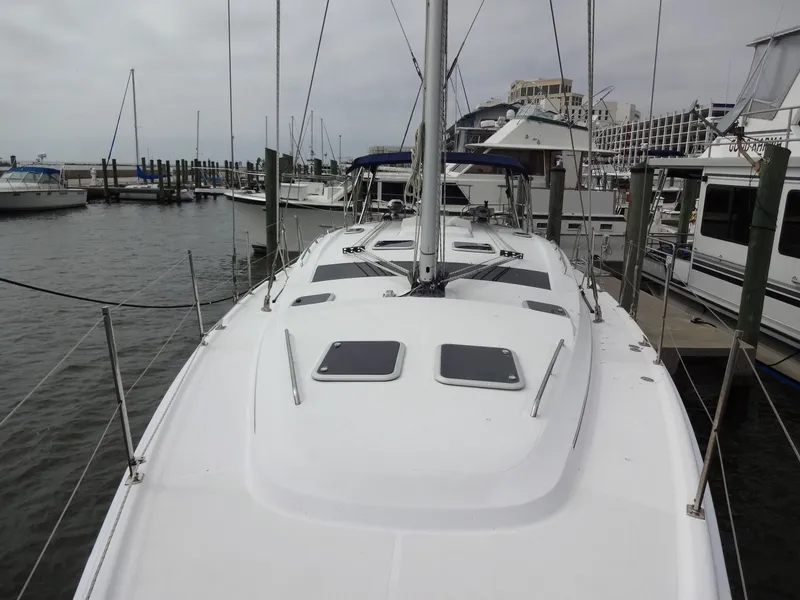Slide: The Image of A 2009 Hunter 50 sailboat docked in a marina, surrounded by other boats. - 22