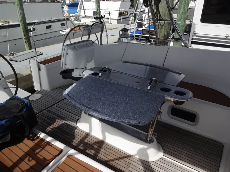 Slide: The Image of The image shows the cockpit of a 2009 Hunter 50 with a table and seating area. - 14